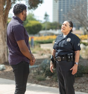 Police officer advocating for social justice with community member